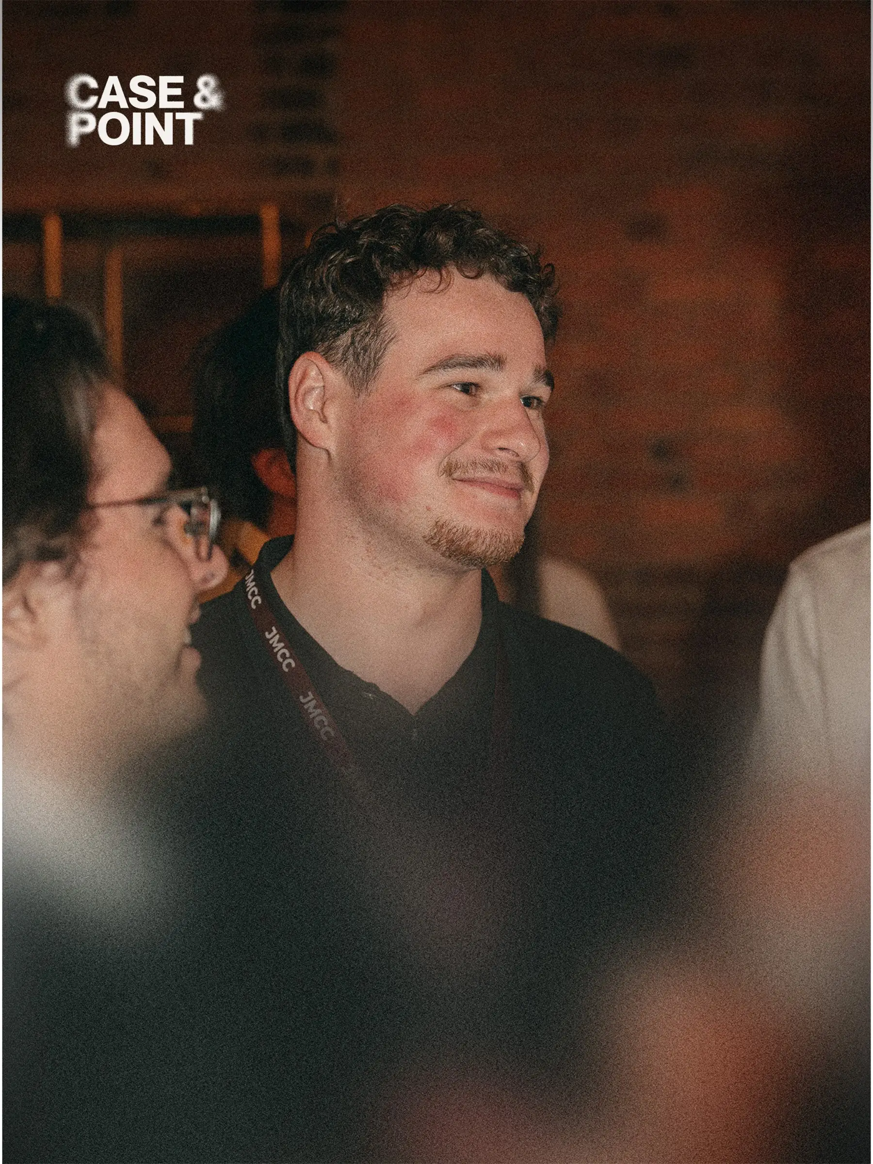 Two JMCC delegates talking and smiling at an indoor networking event