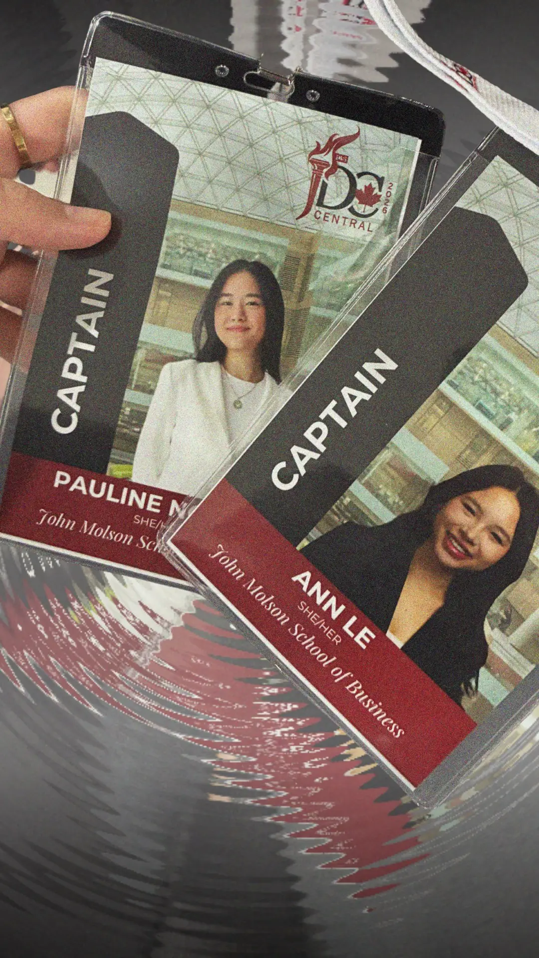 A hand holding two JDCC delegation name badges, both marked CAPTAIN