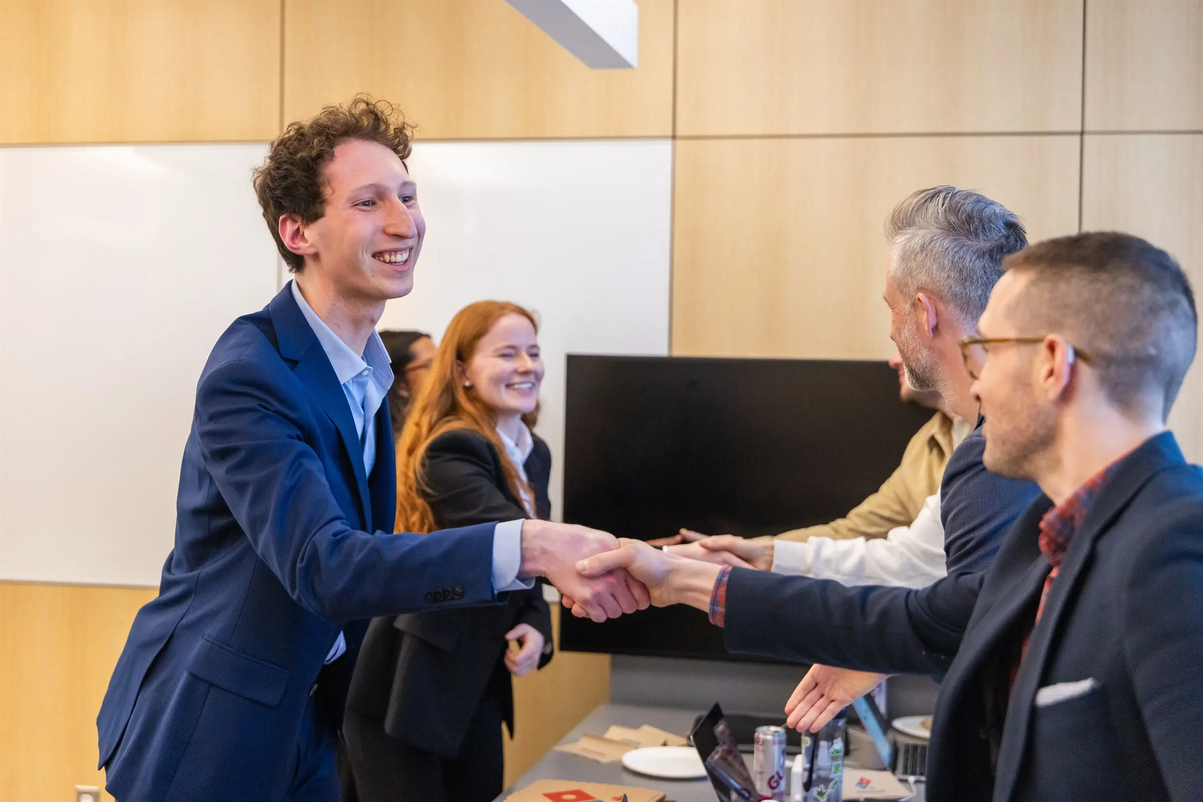 A JMCC delegate shaking hands with judges after presenting a case